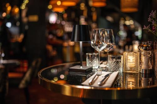 a table with a wine glass and napkin at Ambassador City Centre Hotel in Haarlem