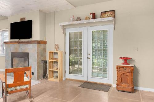 a living room with a tv and a fireplace at Lodge At Tellico in Tellico Plains