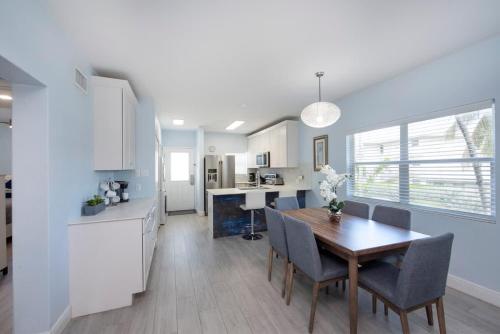 a kitchen and dining room with a table and chairs at Plantation Village #37 Condo in Seven Mile Beach