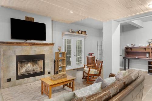 a living room with a couch and a fireplace at Lodge At Tellico in Tellico Plains