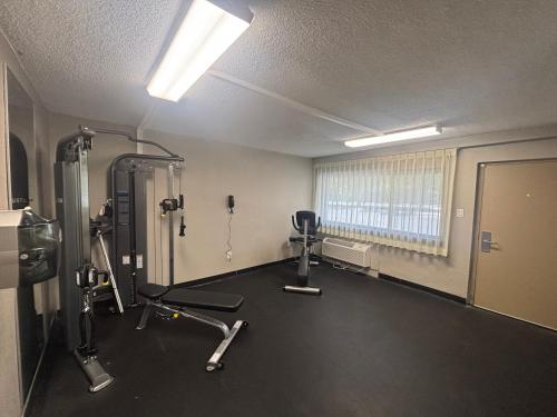 a room with a gym with machines and a window at Ramada by Wyndham West Atlantic City in West Atlantic City