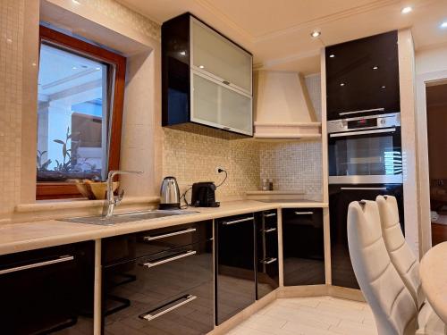 a kitchen with a sink and a counter at Apartmani IBRA in Lucija