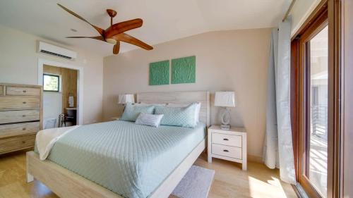 a bedroom with a bed and a ceiling fan at Seven Mile View Condo #1 in West Bay