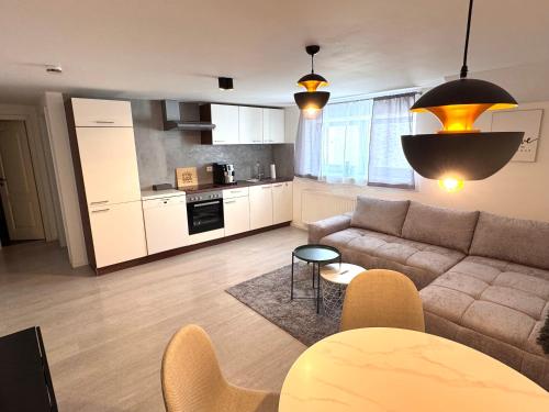 a living room with a couch and a kitchen at 2-Zimmer Souterrain Wohnung in Kehl am Rhein