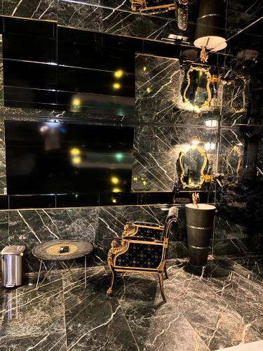 a room with a table and a chair in a room at Suite Versace in Montpellier