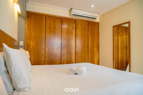 a bedroom with a bed with two towels on it at Interatlântico by Qavi in Natal