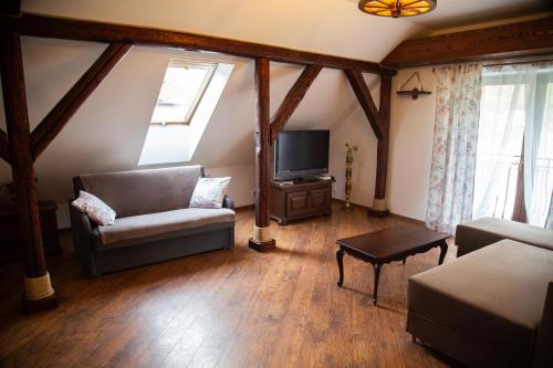 a living room with a couch and a tv at Apartament Rustykalny in Ostrowiec Świętokrzyski