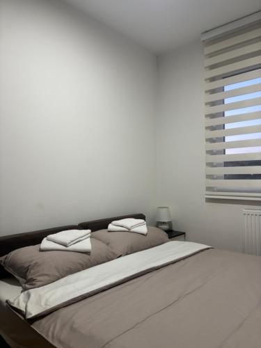 a bed with two pillows on it in a bedroom at Apartman Pale - Biljana in Pale