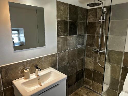 a bathroom with a sink and a shower at Ebogaard in Hillerød