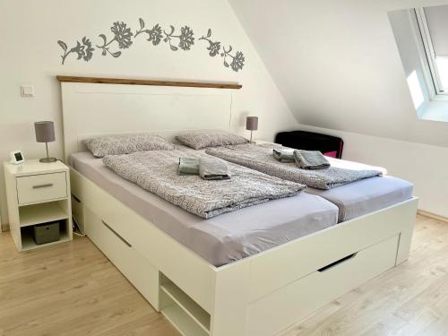 a bedroom with a large white bed with two pillows at Leuchtturm in Juist