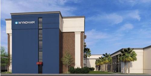 a rendering of a building with a sign on it at Wyndham New Orleans Airport & Conference Center in Kenner