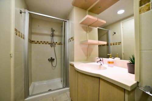 a bathroom with a sink and a shower at Laouri Traditional 2-Bedroom in Kalopanayiotis in Kalopanayiotis