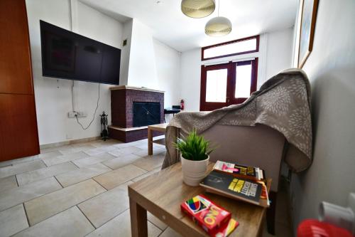 a living room with a couch and a fireplace at Laouri Traditional 2-Bedroom in Kalopanayiotis in Kalopanayiotis