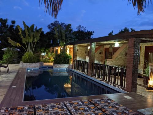 a house with a swimming pool at night at Inside Afrika Boutique Hotel in Kigali