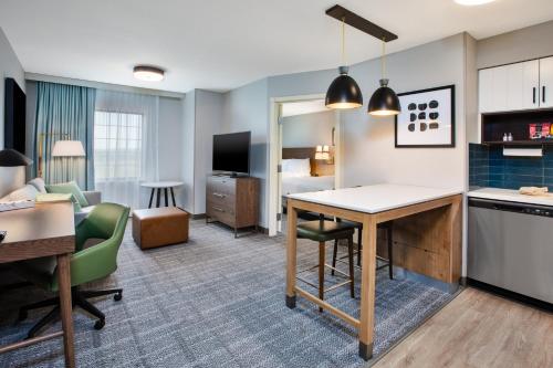 a hotel room with a kitchen and a living room at Staybridge Suites Bismarck by IHG in Bismarck
