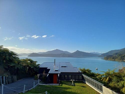 a house with a view of a body of water at Moetapu Scenic Retreat in Linkwater