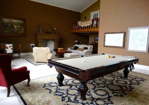 a living room with a pool table in it at Erik's Ranch in Livingston