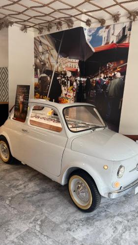an old white car is parked in a garage at Miami Sun Hotel - Downtown/Port of Miami in Miami