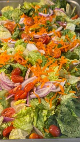 a salad with lettuce tomatoes onions and other vegetables at Miami Sun Hotel - Downtown/Port of Miami in Miami