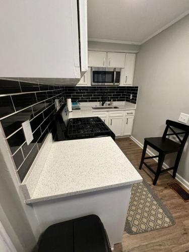 a small kitchen with a stove and a sink at 2 Kitchenssleeps 105 Car Parking in Atlanta