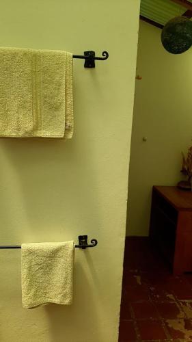 two towels hanging on a wall in a bathroom at The Black Sheep Inn in Chugchilán