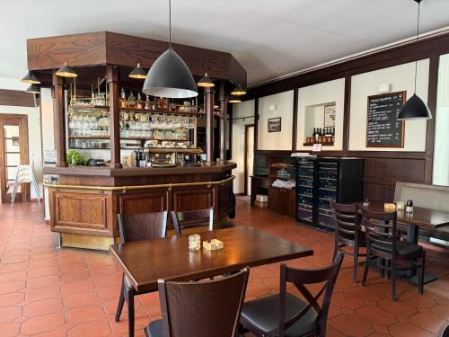 a restaurant with tables and chairs and a bar at Bechnerův statek in Lány