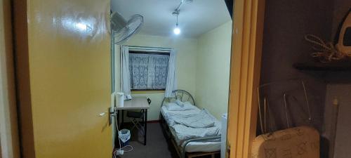 a hospital room with a bed and a window at Basildon House of Muralist in Basildon