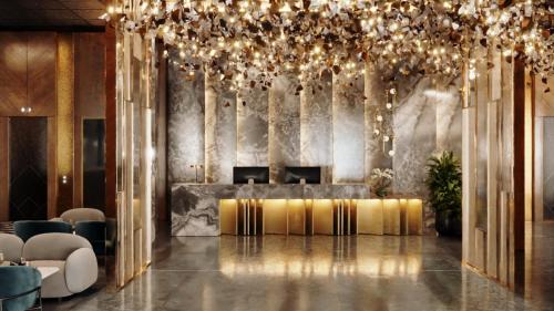 a lobby with a table and a chandelier at Jewelz by Kings Hotel in Georgetown