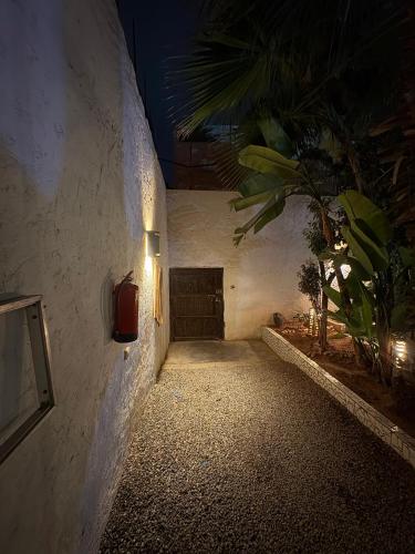 a hallway with a light on the side of a building at ASARAG GUEST HOUSE & Lodge in Mirleft