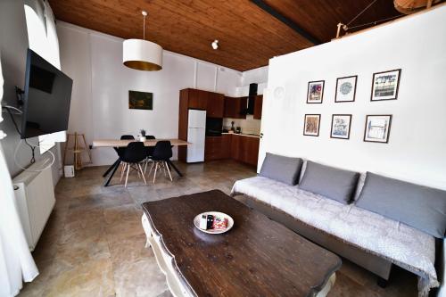 a living room with a couch and a table at Laouri Traditional 1-Bedroom in Kalopanayiotis in Kalopanayiotis