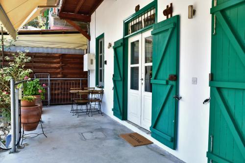 an entrance to a house with green doors at Laouri Traditional 1-Bedroom in Kalopanayiotis in Kalopanayiotis