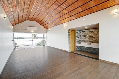 an empty room with a wooden ceiling at OAK Edassery's Sealine Villa Stay in Cochin