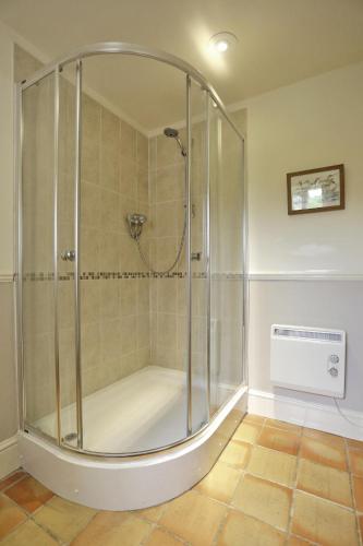 a shower with a glass enclosure in a bathroom at Old Farm in Walberswick