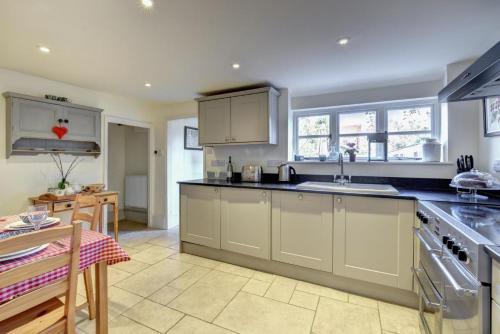 a kitchen with a sink and a counter top at Lismore Cottage in Orford