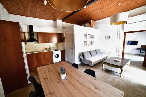 a living room with a table and a couch at Laouri Traditional 1-Bedroom in Kalopanayiotis in Kalopanayiotis