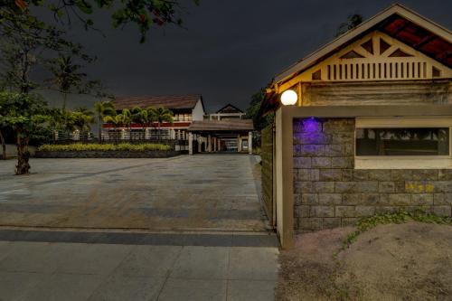 a building with a light on the side of it at OAK Edassery's Sealine Villa Stay in Cochin