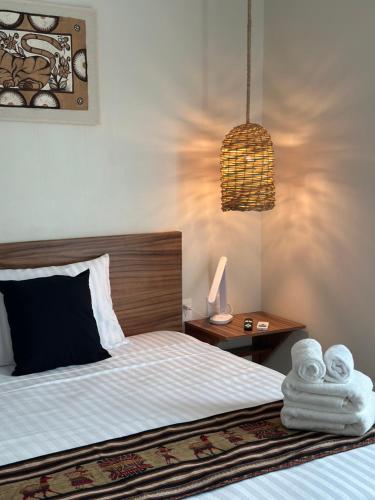 a bedroom with a bed with towels on it at Apartment OceanView near Bacalar in Mahahual
