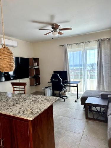 a kitchen and living room with a ceiling fan at Apartment OceanView near Bacalar in Mahahual