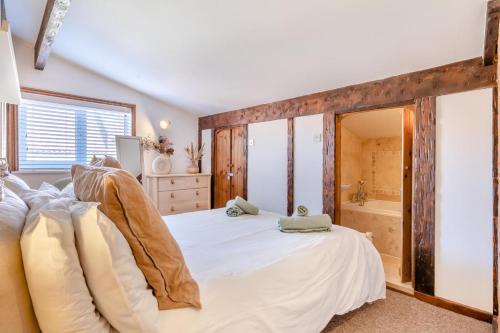 a bedroom with a large bed and a tub at The Anchorage in Sheringham