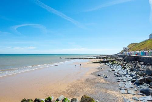 a beach with a bunch of rocks and the ocean at The Anchorage in Sheringham