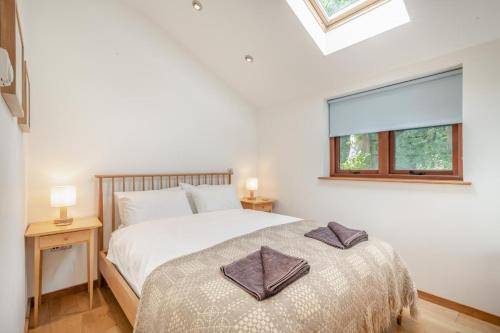 a bedroom with a bed with two pillows on it at Pelican Barn in East Carleton