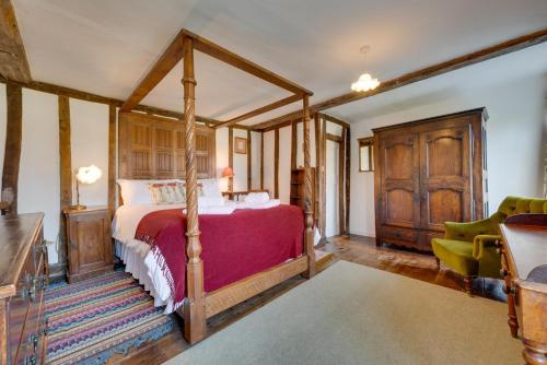 a bedroom with a canopy bed in a room at Old Brewery House in Orford