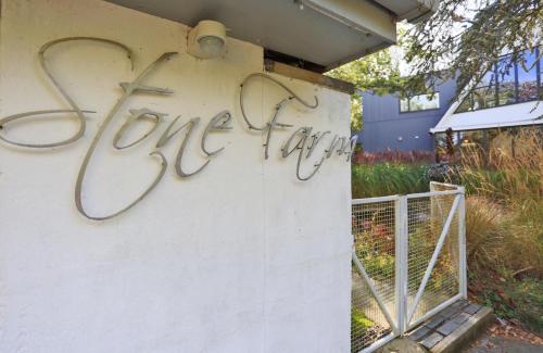 a sign on the side of a building with graffiti at Stone Farm in Lavenham