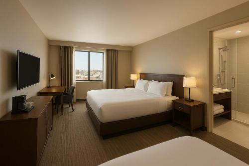 a hotel room with a bed and a desk at Hotel Urban Lion - IGI Airport Delhi in New Delhi