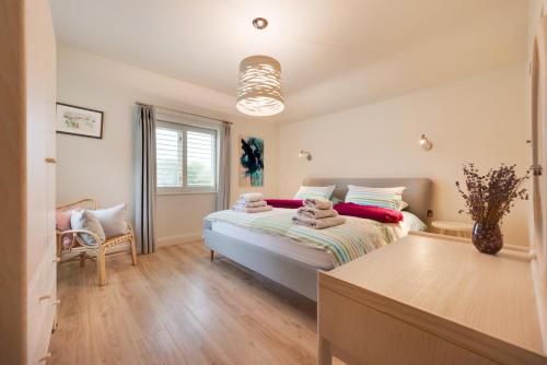 a bedroom with a bed and a window at Rose Cottage in Middleton