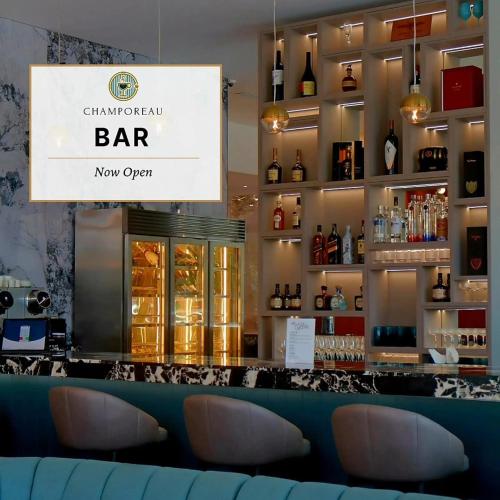 a bar with a sign that reads champagne bar now open at Jewelz by Kings Hotel in Georgetown