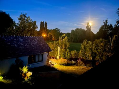a view of a house at night at Côté Rivière in Ézy-sur-Eure