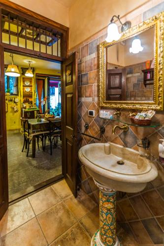 a bathroom with a sink and a mirror at L'Antico Loco Commodo in Viterbo