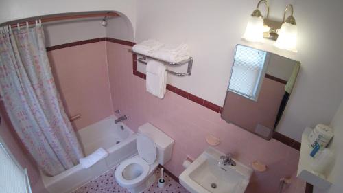 a bathroom with a toilet and a sink at King Charles Hotel in Ocean City