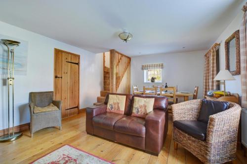 a living room with a couch and chairs and a table at 17 The Green in East Rudham